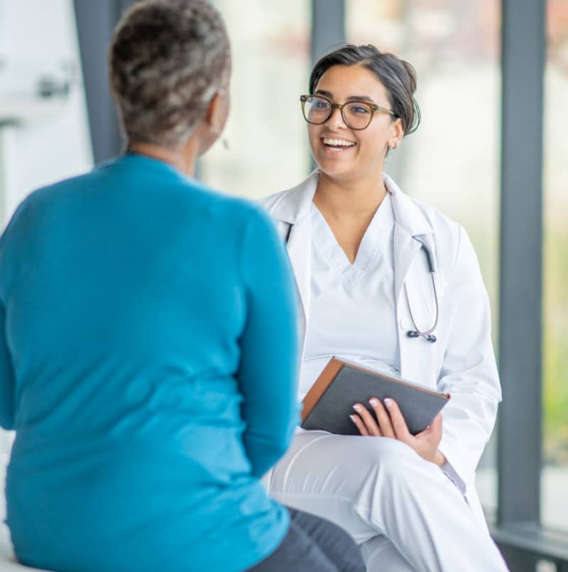 doctor smiling while speaking to patient